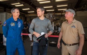 NASA Astronaut Drew Feustel, left, Actor Matt Damon, who stars as NASA Astronaut Mark Watney in the film “The Martian,” and Mars Science Lab Project Manager Jim Erickson, talk at the Jet Propulsion Laboratory (JPL) Mars Yard, Tuesday, Aug. 18, 2015, at JPL in Pasadena, California. While at JPL Damon meet with NASA scientists and engineers who served as technical consultants on the film. The movie portrays a realistic view of the climate and topography of Mars, based on NASA data, and some of the challenges NASA faces as we prepare for human exploration of the Red Planet in the 2030s. Photo Credit: (NASA/Bill Ingalls)