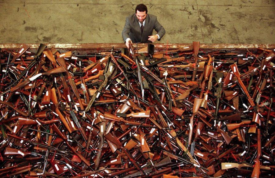 Mick Roelandts, firearms reform project manager for the New South Wales Police, looks at a pile of about 4,500 prohibited firearms in Sydney that have been handed in over the past month under the Australian governments buy-back scheme July 28. A total of 470,000 guns have been collected nationally, with owners receiving A$243 million (US$180 million) in compensation. The scheme was set up due to tighter gun laws brought in after the April 1996 Port Arthur massacre in which 35 people died when a lone gunman went on a shooting rampage. - RTXHDPH