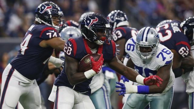 HOUSTON%2C+TX+-+AUGUST+30%3A++Alfred+Blue+%2328+of+the+Houston+Texans+carries+the+ball+defended+by+Kony+Ealy+%2376+of+the+Dallas+Cowboys+in+the+first+half+of+the+preseason+game+at+NRG+Stadium+on+August+30%2C+2018+in+Houston%2C+Texas.++%28Photo+by+Tim+Warner%2FGetty+Images%29
