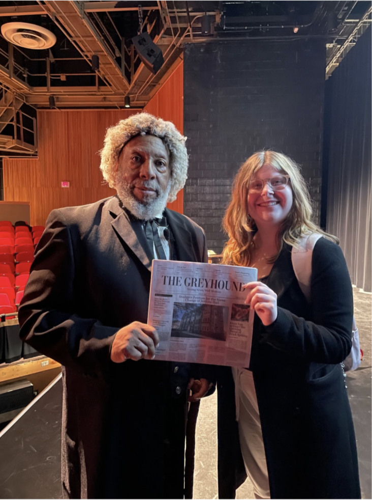 Photograph of Editor in Chief Jacqueline Goldman alongside Fredrick Douglass reenactor holding up The Greyhound print edition